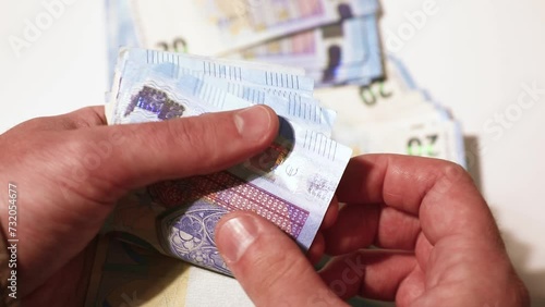 Counting the money in hands. 20 euro bills. Stacks of banknotes on the table. Close-up stock video photo
