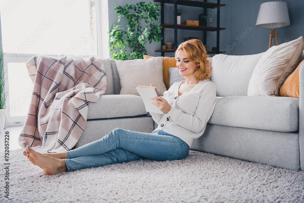 Full body profile portrait of gorgeous positive lady sit carpet floor hold pen notepad take notes free time house inside Full body profile portrait of gorgeous positive lady sit carpet floor hold pen notepad take notes free time house inside