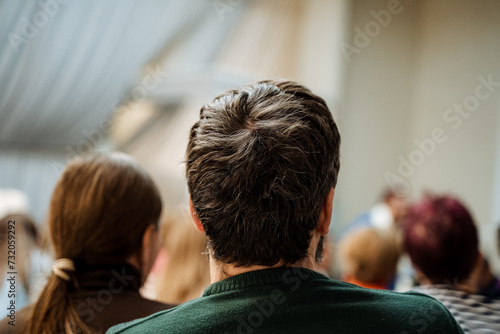 Obraz na plátne Audience at a business conference intently listening to a speaker on stage