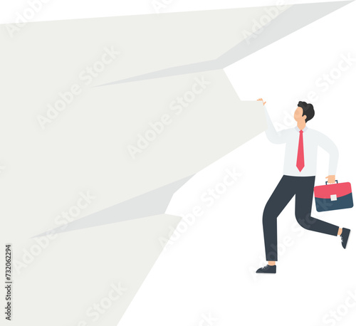 Businessman hanging on a cliff 