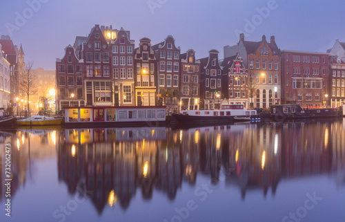 Typical houses and bridge at Amsterdam canal Brouwersgracht at night, Holland, Netherlands