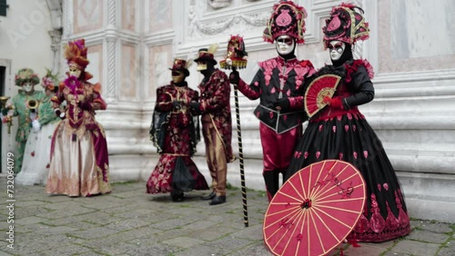 Venice, Italy - February 2024 - carnival masks are photographed with tourists in San Marco square