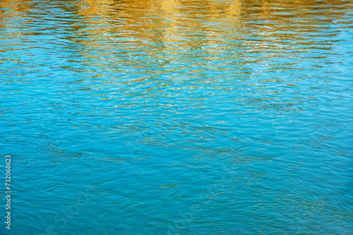 Background of the water surface of the Salzach river. Texture of water of a mountain river.