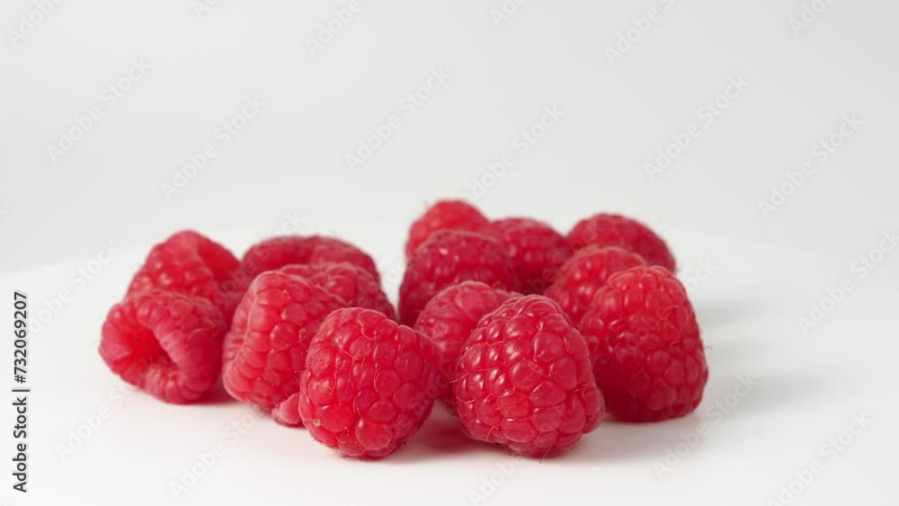 Raspberries rotate on a white background. Raspberry close-up. Raspberries rotate on a white background. Raspberry close-up.