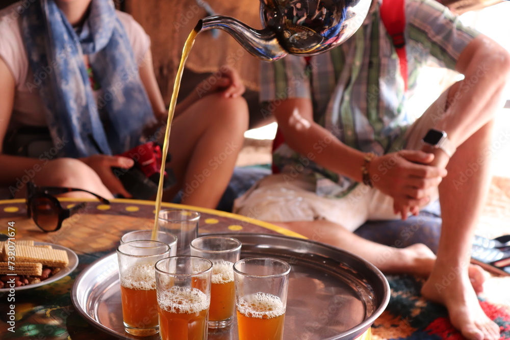 Ταπετσαρία Silver oriental teapot and tea cups to drink traditional moroccan tea in local bedouin nomad tent camp at sand dunes in african hot Sahara desert near Merzouga, Morocco, Africa