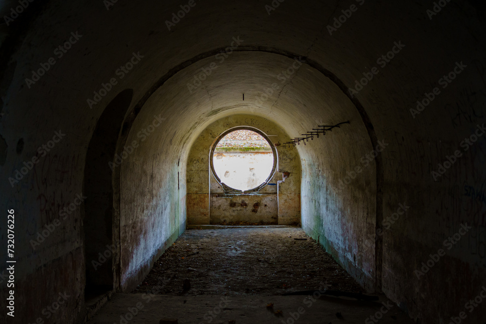 Obraz premium Siedliska, Subcarpathian, Poland - 25 November 2023: Fort GHW I „Salis-Soglio” - interior of the residential casemate with a round window for 10 soldiers 