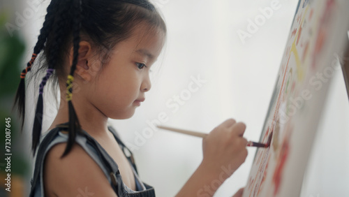 little girl drawing in the living room