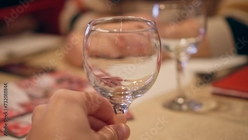 Man holding an empty wine glass in restaurant, closeup shot of male hand, cinematic 4K video