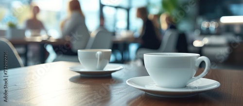 Close up cups of coffee or tea on the table in the blur office workers background. AI generated