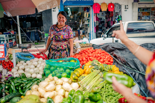 Latina vendor from a cantonal market talks to a buyer. photo