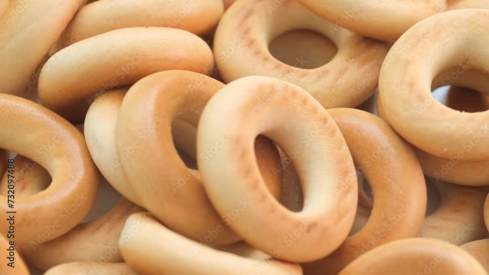 Assortment of bagels, a staple food, on a wooden table with holes. Assortment of bagels, a staple food, on a wooden table with holes.