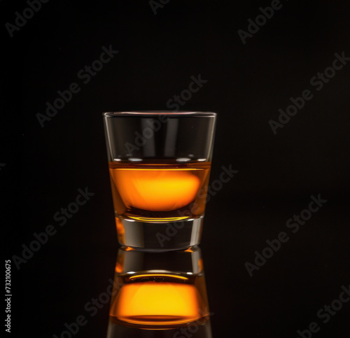 A layered B-52 shot in a clear glass, with a dark background, suitable for a bar's specialty shots promotion or menu