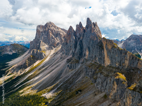 High cliff of Seceda mountains covered with green grass. 