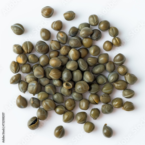 A top view of a heap of fresh capers isolated on a white background. These small, green, round buds are a popular Mediterranean ingredient known for their unique flavor