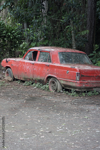 broken car in abandoned forest red background portrait wallpaper.