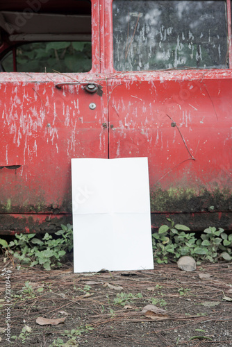 white blank poster for mockup on a damaged car in an abandoned forest, red background, potrait 1 (ID: 732109475)