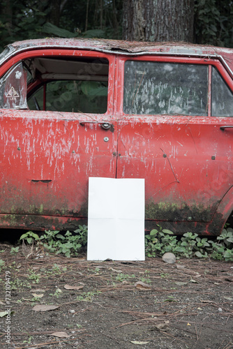 white blank poster for mockup on a damaged car in an abandoned forest, red background, potrait 4 (ID: 732109479)