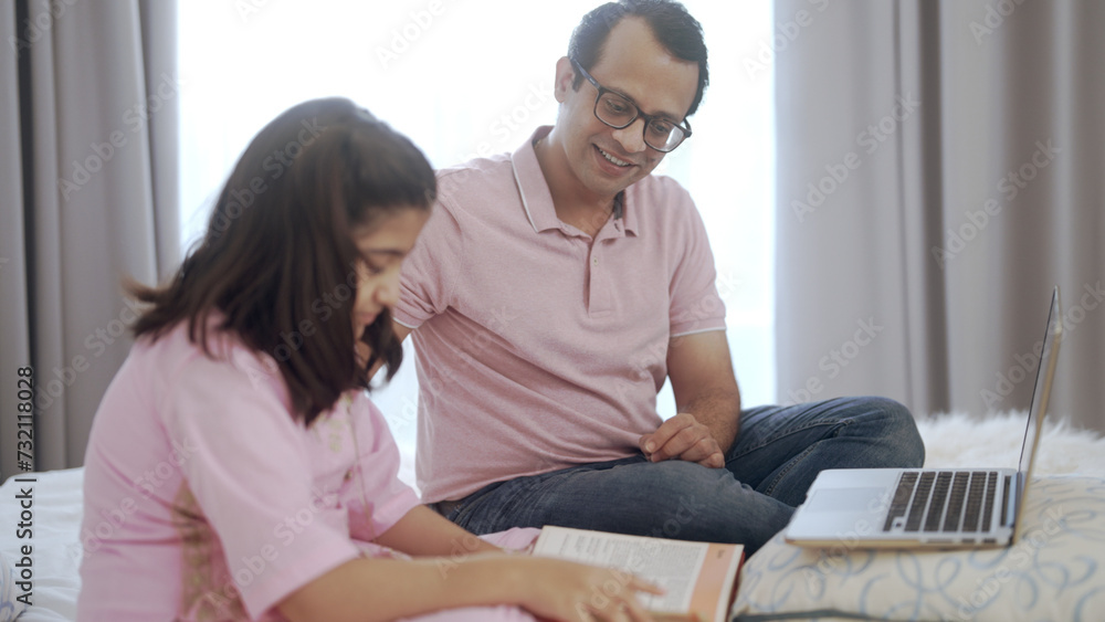 Father teaching daughter to do homework 