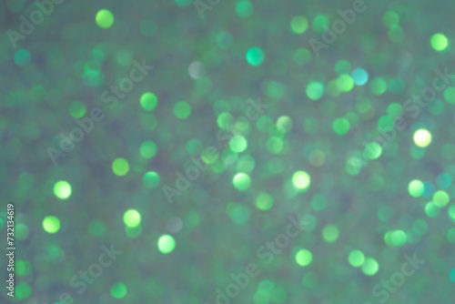 Sparkles defocus light. Glitter paper defocus as background. Green background with defocus.