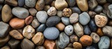 A collection of rocks with varying sizes and colors, resembling a pile of natural materials, including pebbles, rocks, and cobblestones