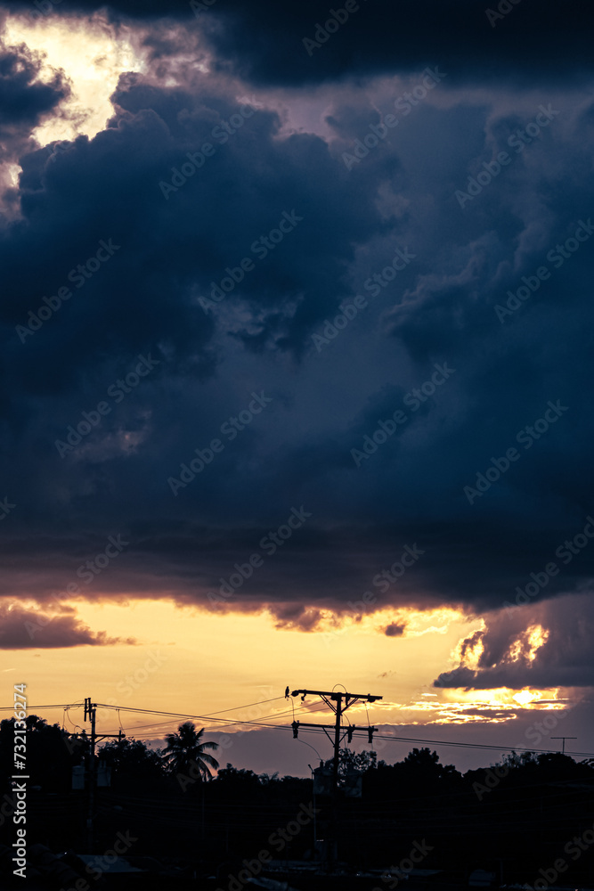 Dramatic sky with stormy clouds at sunset. Nature background