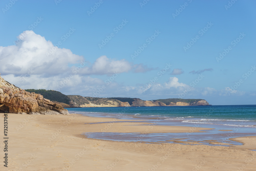 Praia das Furnas beach on a sunny day with clear blue sky, Algarve, Portugal.