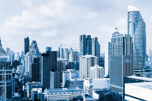 Closeup image of Bangkok cityscape. Modern skyscrapers with monochrome blue filter. Modern architectural building skyline with blue sky. Side view. Business background. Day light. Ornamented.