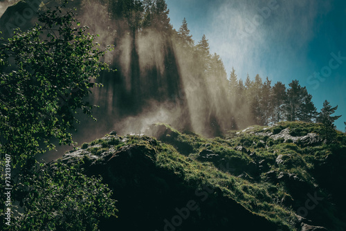 Large Hesjedalsfossen waterfall next to the road in Hordaland, Norway. Long exposure of flowing water. Water cascading down the stones in the forest. Fairy-tale and mysterious atmosphere, no people. photo