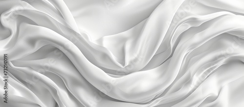 A close up of liquid-like waves on a petal-white satin fabric, resembling an artful, grey water pattern on luxurious silk linen.