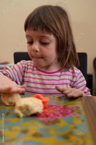 Little girl preparing cookies to be baked