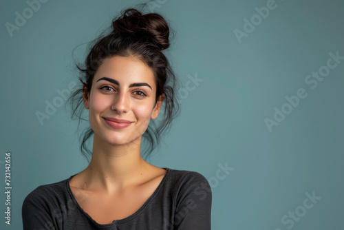 Studio shot of an Attractive Beautiful smiling woman looking at the camera on a colored flat background