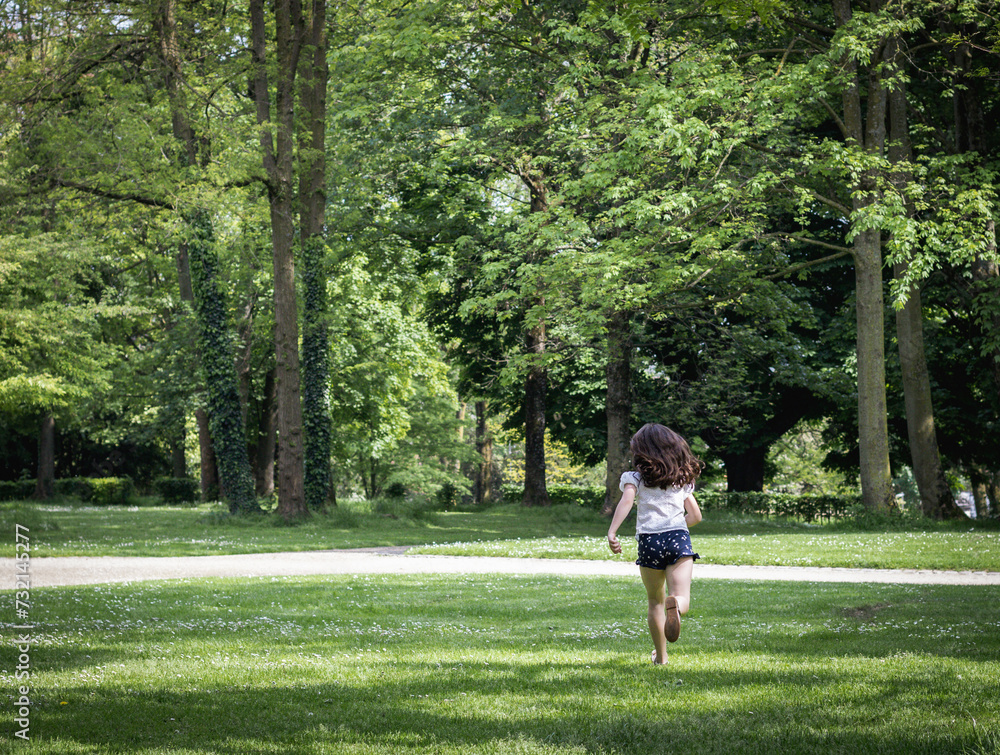 One running girl in the park on a summer day. One running girl in the park on a summer day.