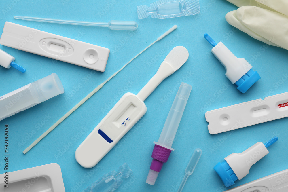 Disposable express test kits on light blue background, flat lay Disposable express test kits on light blue background, flat lay