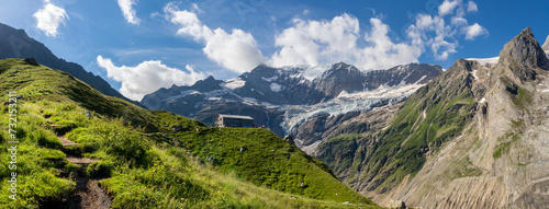 The massif of Grosses Fiescher horn peak and Berghaus Baregg chalet - Switzerland - Grindelwald. photo