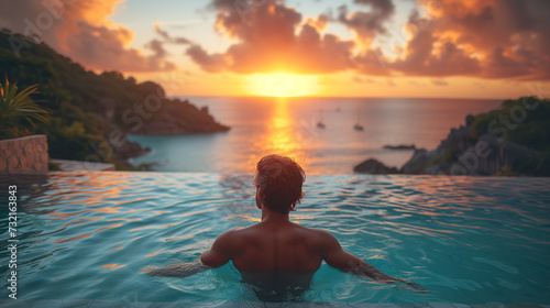 person watching the sunset from swimming pool  Luxury swimming pool in a tropical resort  relaxing holidays i