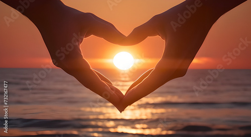 Hand creates heart shape under sunny sky  a happy gesture. person forms a heart shape with their hand against the backdrop of the sun  symbolizing happiness and love in the vast natural landscape.