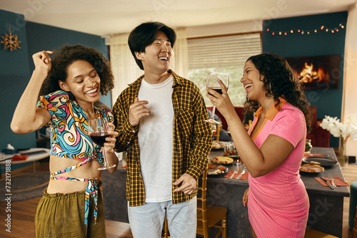 Group of young smiling friends having party and dancing at home. Friendship life style concept 
