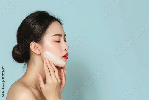 Skincare Model beauty care. Well groomed woman uses hand sanitizer, cleansing action lip balm, lotion & eye patch. Face cream leontopodium jar hyperpigmentation pot photo