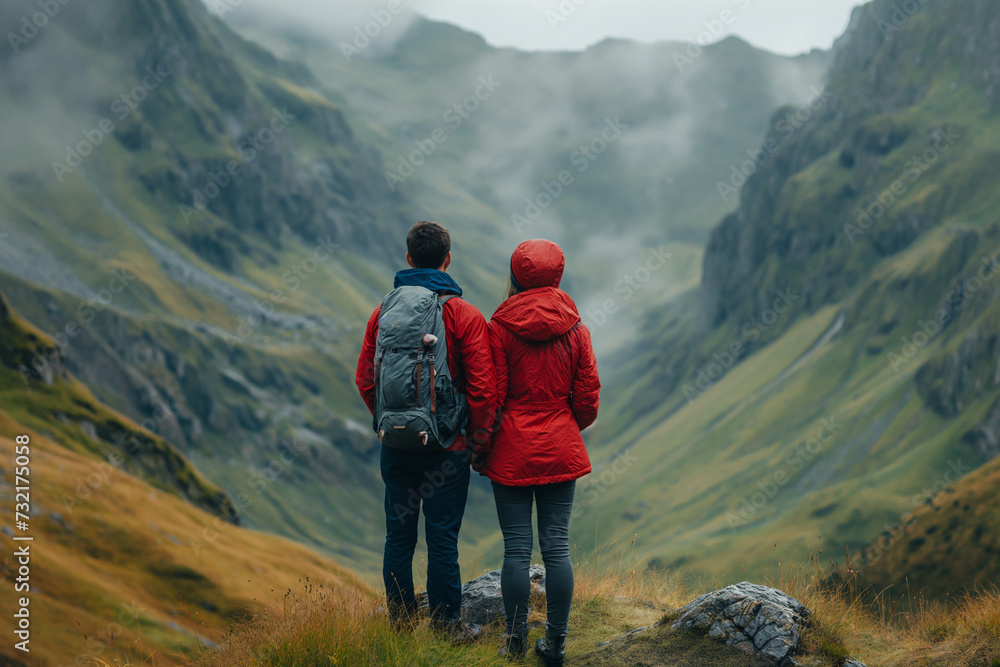 Highland Companionship: Explorers Gazing Over Misty Mountains