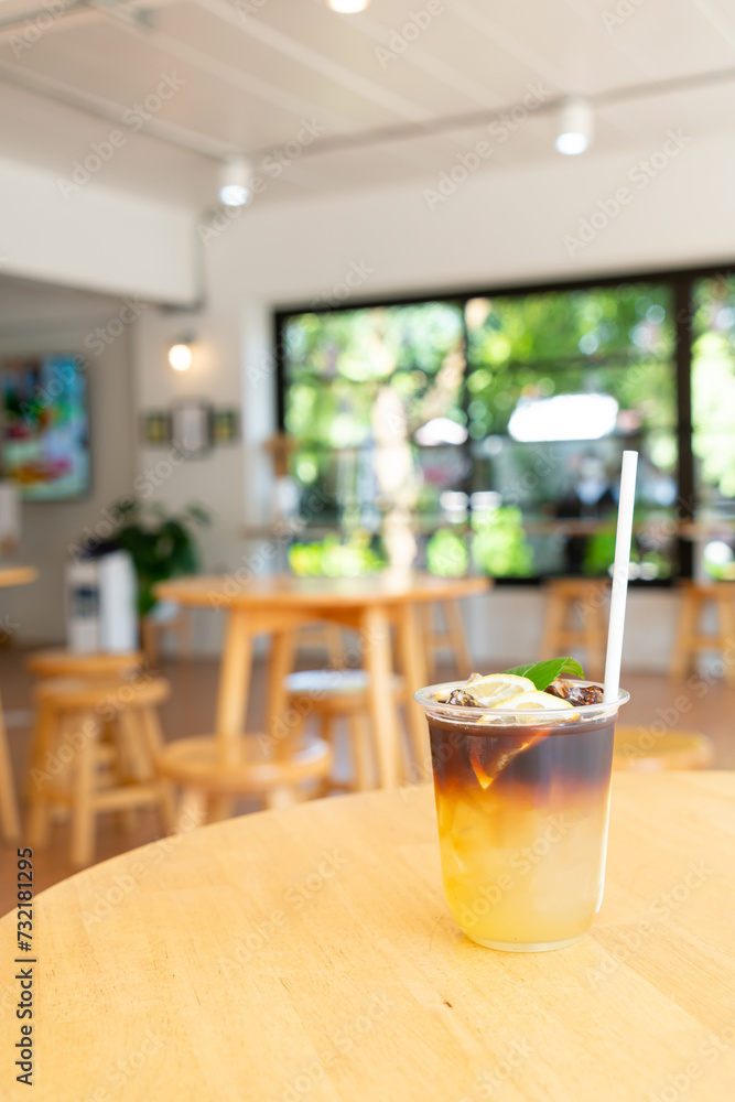 lemon with black coffee in glass lemon with black coffee in glass