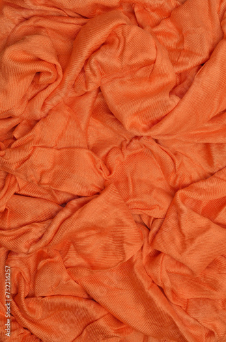 Orange crumpled textile background.