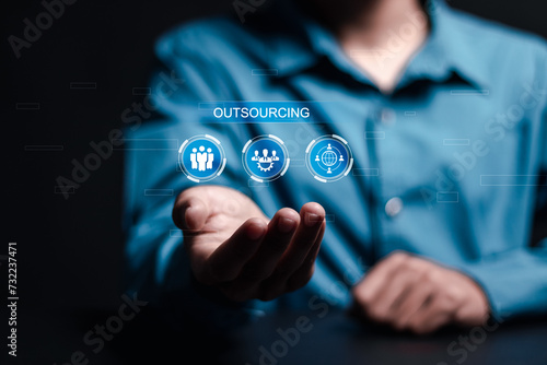 Outsourcing concept. Human resources and global recruitment for business. Person hold virtual outsourcing icon for business working and company.