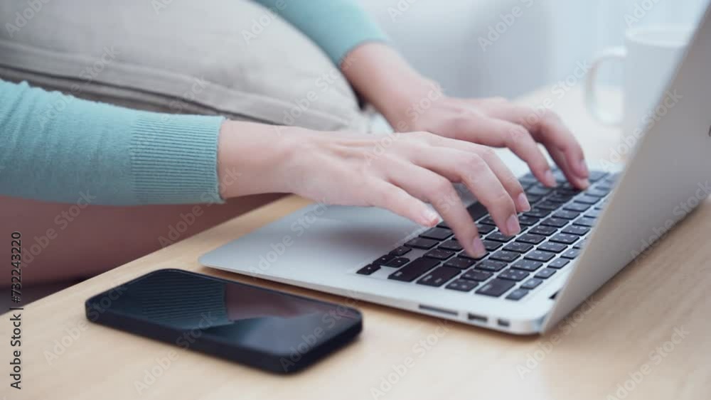 A casual setting with a person typing on a laptop next to a smartphone, highlighting multitasking and connectivity. A casual setting with a person typing on a laptop next to a smartphone, highlighting multitasking and connectivity.