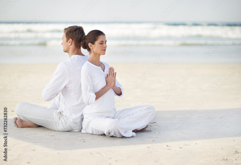 Couple, yoga and sea with meditation, sitting or waves by sand in morning with mindfulness outdoor. Man, woman and peace for namaste with spiritual growth, balance or zen at beach in Cape Town