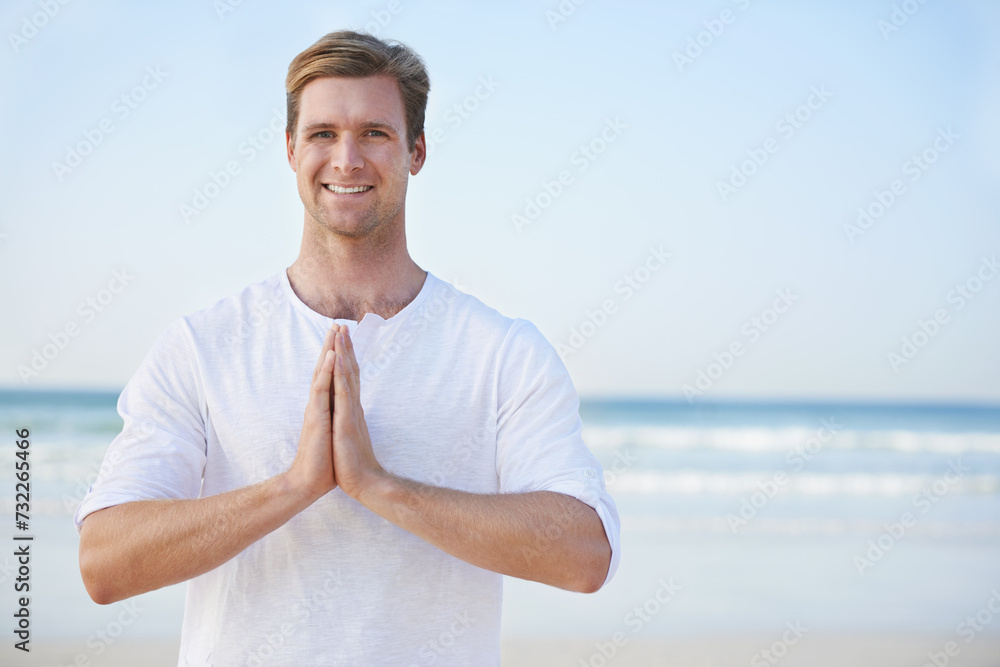 Man, yoga and beach with smile in portrait for peace, zen and space for mockup on vacation with meditation. Person, ocean and outdoor in summer for namaste with nature on spiritual journey by sea