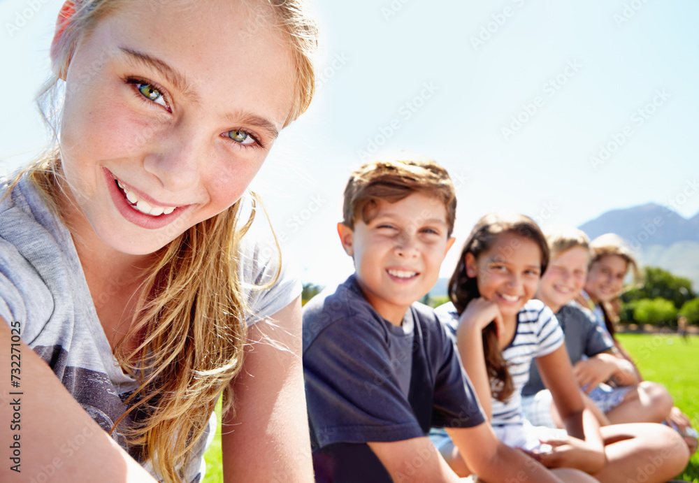 Fototapeta premium Children, friends and portrait in nature or relax on academy trip for adventure, learning or summer. Girls, boys and face in park for sunshine or bonding group or class together, outdoor or explore