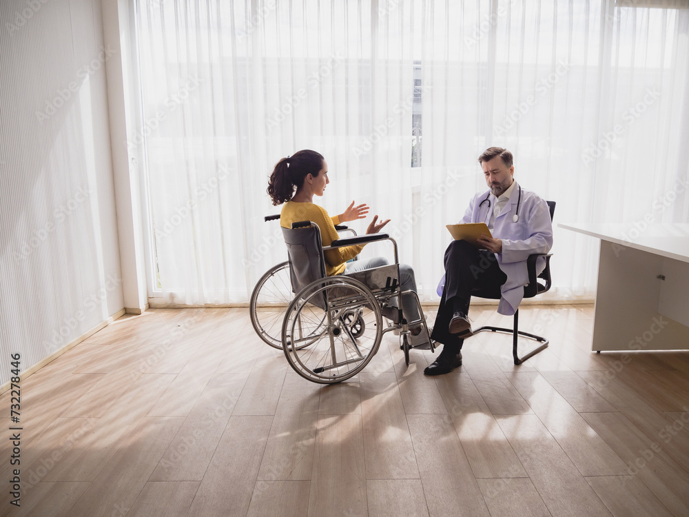 Portrait latin american woman sick sit wheelchair with man doctor caucasian sitting two people check and treat patients talk helping support explain medicine sick person inside hospital room service Portrait latin american woman sick sit wheelchair with man doctor caucasian sitting two people check and treat patients talk helping support explain medicine sick person inside hospital room service