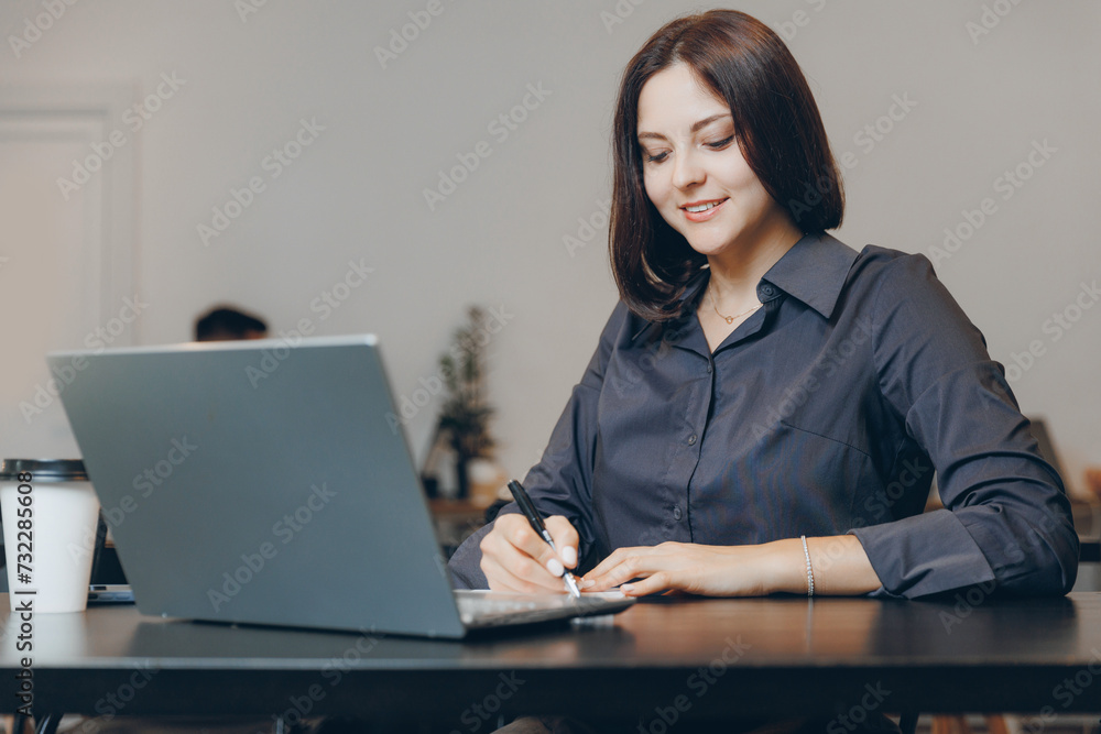 Young female use notebook student doing assignments in cafe, student lifestyle Young female use notebook student doing assignments in cafe, student lifestyle