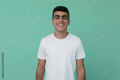 Studio shot of a young Middle Eastern man with blank white t-shirt. T-shirt mockup design