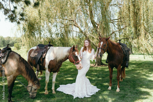 Group of horses with a bride in a lace wedding dress © Cavan